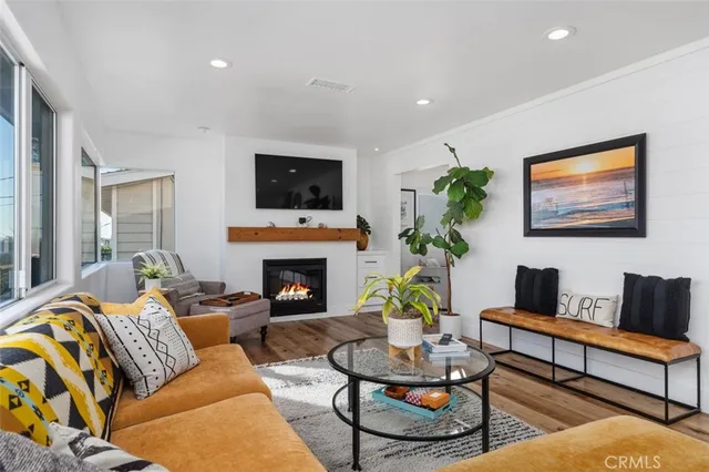 a living room with furniture a fireplace and a flat screen tv