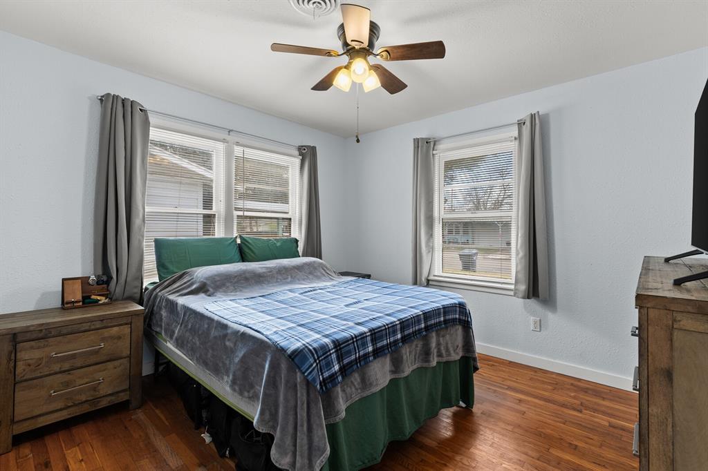 2506 South 24th Street Waco, TX 76706 - Photo 30 of 39 a bedroom with a bed and a chandelier