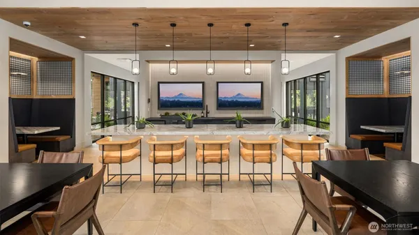 a living room with stainless steel appliances kitchen island granite countertop a table and chairs in it