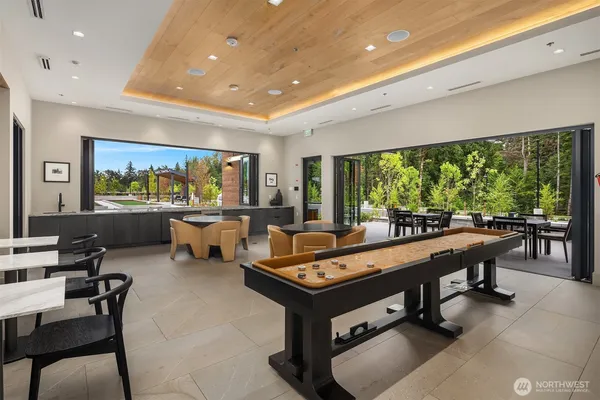 a living room with patio furniture and a large window