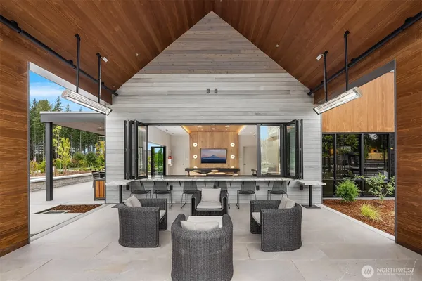 a view of a patio with table and chairs potted plants with wooden floor