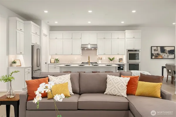 a living room with furniture and kitchen view