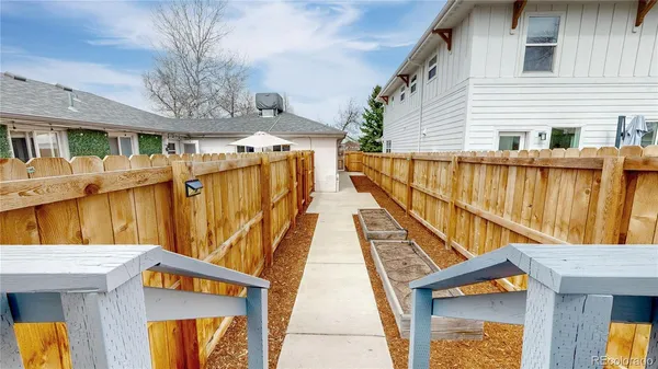 a view of a house with wooden fence