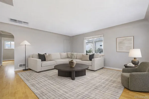 a living room with fireplace furniture and a wooden floor