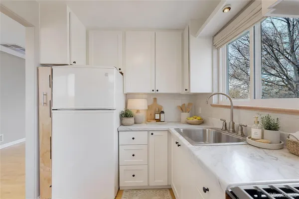 a kitchen with appliances a sink and a window