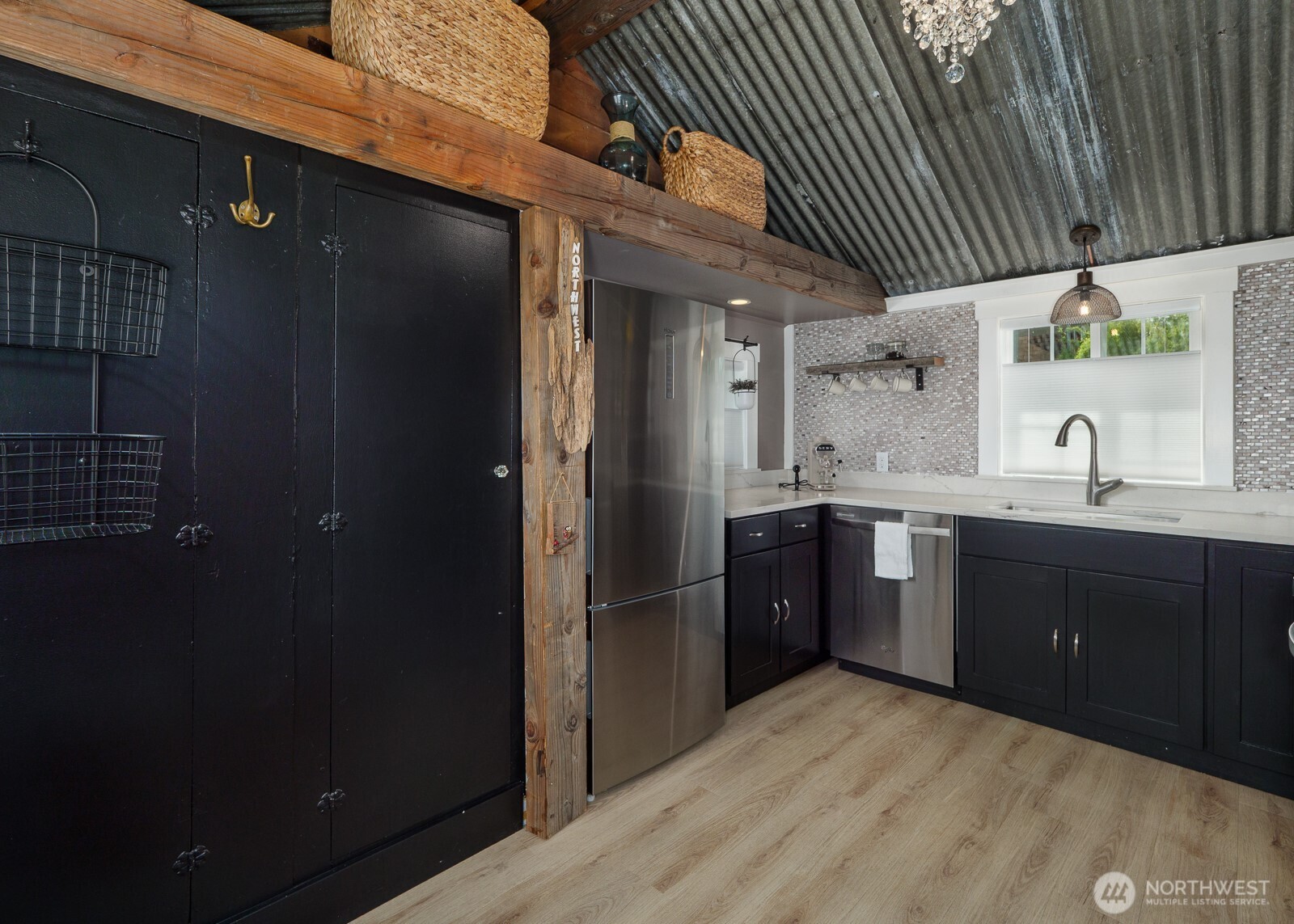 233 West Washington Street Sequim, WA 98382 - Photo 13 of 40 a kitchen with a sink a refrigerator and cabinets
