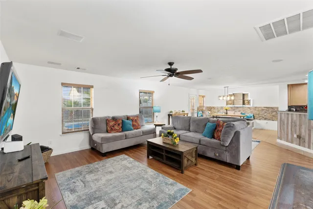 a living room with furniture and wooden floor