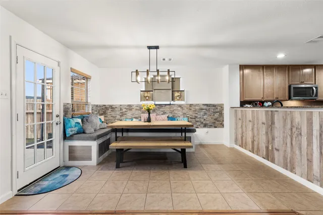 a living room with lots of furniture and a view of kitchen