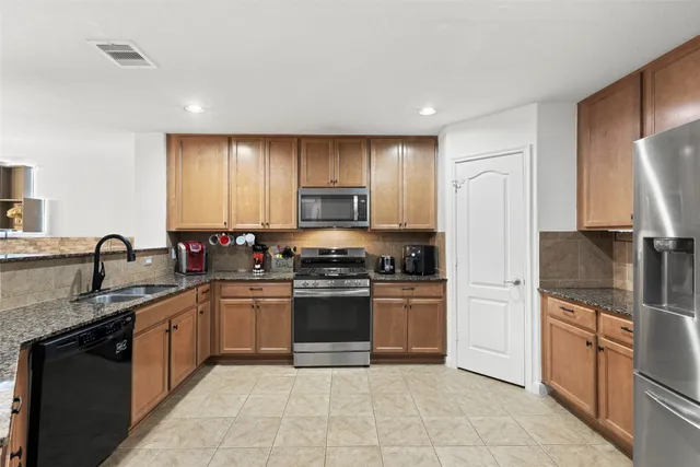 a spacious bedroom with a bed a couch and dresser