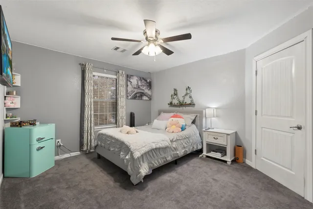 a living room with furniture a ceiling fan and a window
