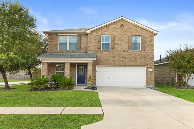 a front view of a house with a garden and plants