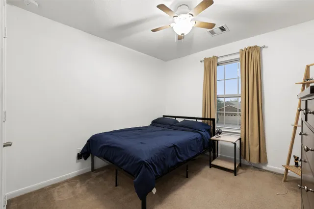 a bedroom with a bed and a television