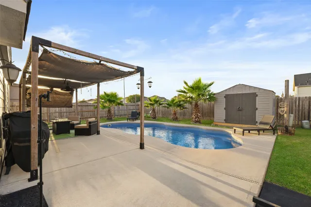 a view of a swimming pool with a patio