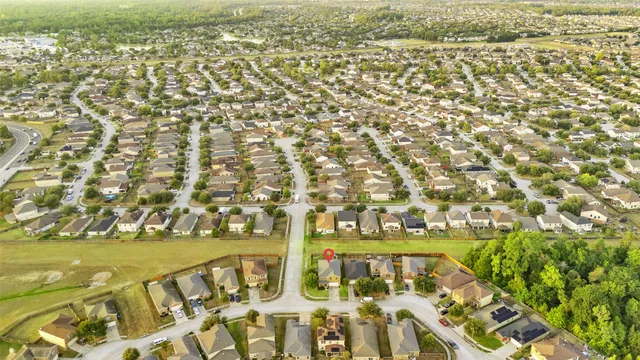 an aerial view of residential houses with outdoor space