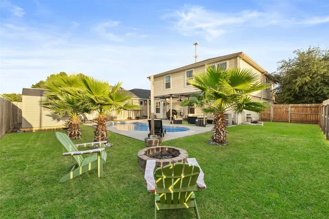 a view of a patio with swimming pool and sitting area