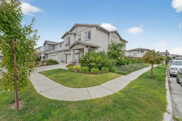 a view of a house with a yard and pathway
