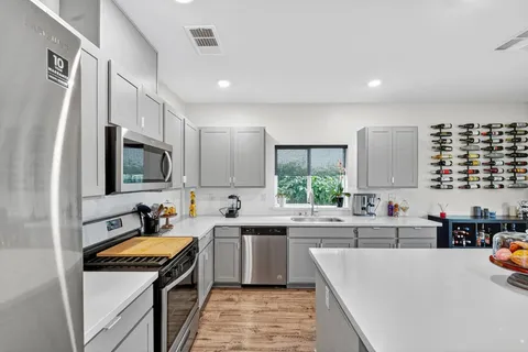 a kitchen that has a sink and a stove in it