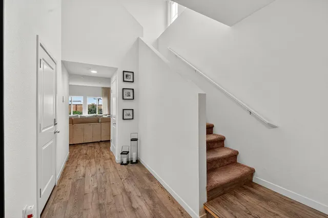 a view of a hallway view with wooden floor and staircase