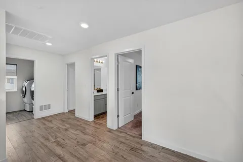 a view of a livingroom with wooden floor and closet