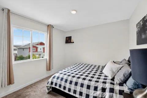 a bedroom with a bed and window