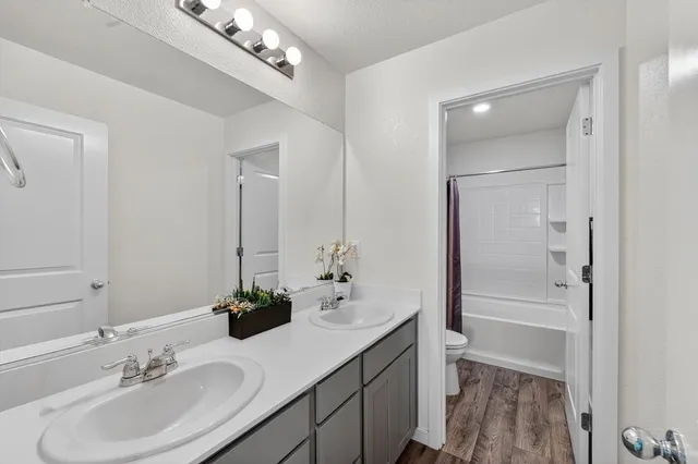 a bathroom with a sink a light fixture and a mirror