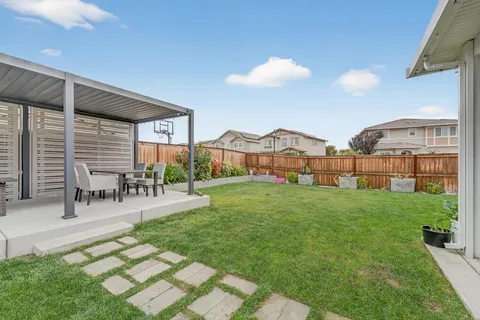 a view of a house with backyard porch and sitting area