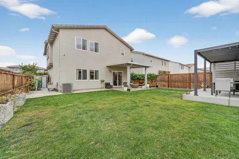 a view of an house with backyard porch and sitting area