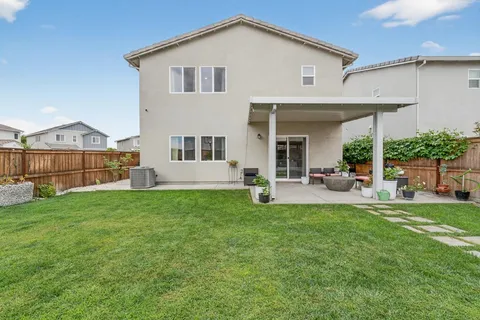 a view of a house with a yard and sitting area