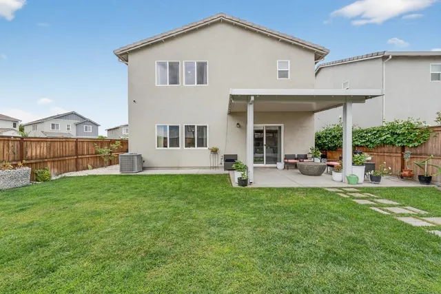 a view of a house with a yard and sitting area