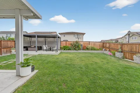 a view of a house with backyard and porch