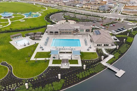 an aerial view of a swimming pool with outdoor seating