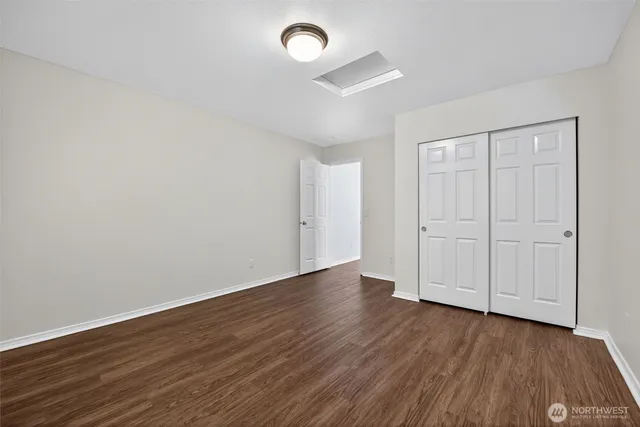 a view of an empty room and wooden floor