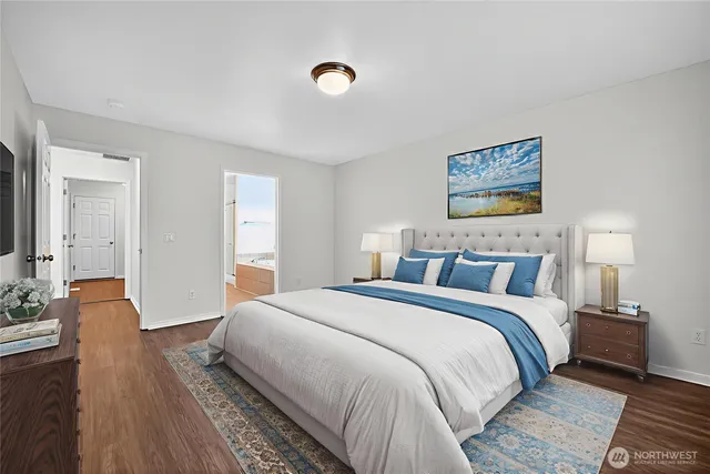 a bedroom with bed and wooden floor