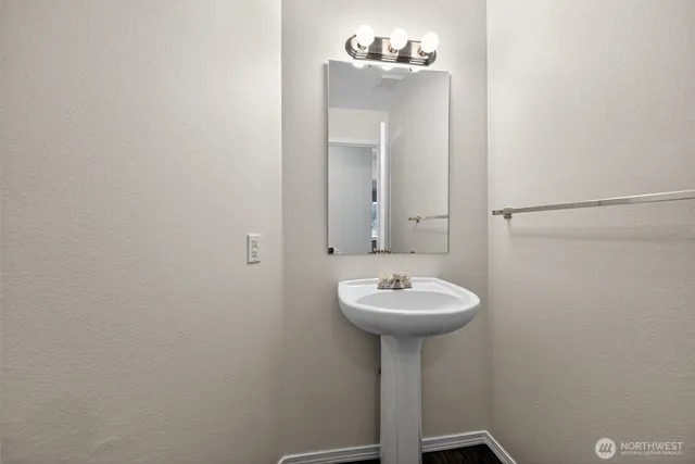 a bathroom with a sink a mirror and a shower