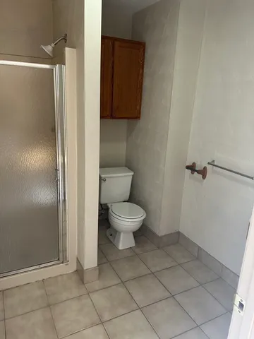 a bathroom with a toilet and a shower