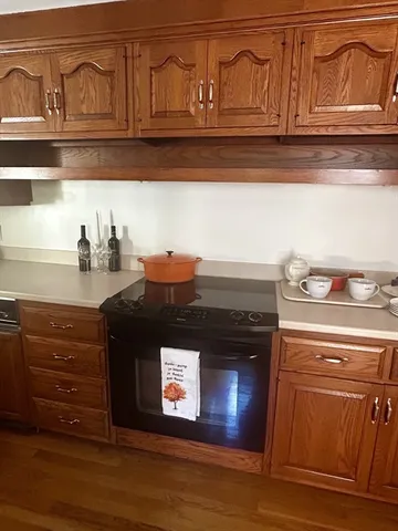 a stove top oven sitting inside of a kitchen