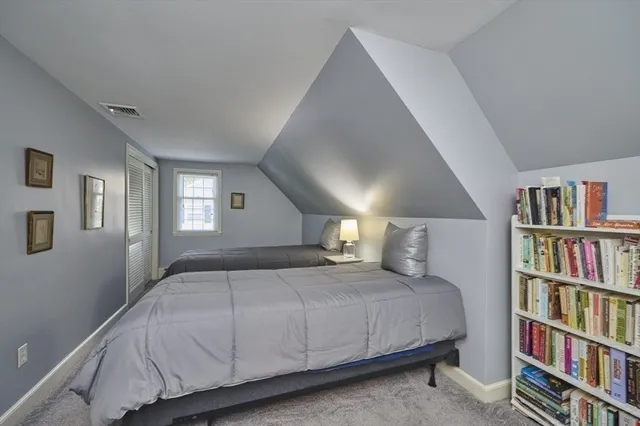 a bedroom with a large bed and a book shelf