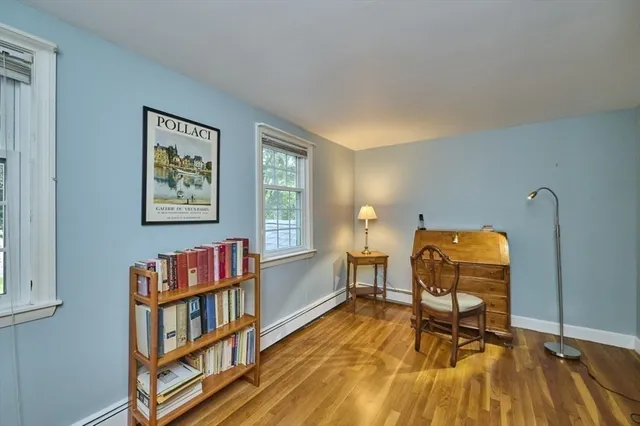 a living room with furniture and a book shelf