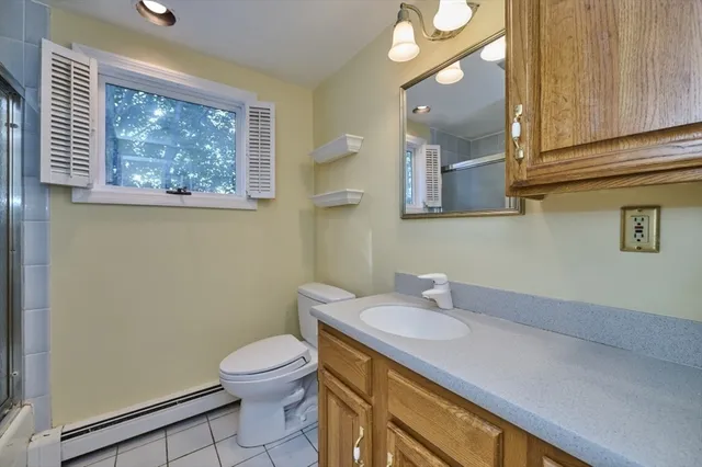 a bathroom with a toilet a sink and mirror