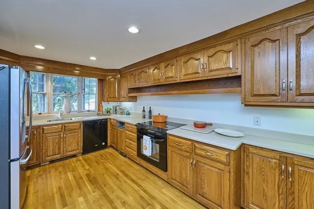a kitchen with stainless steel appliances granite countertop a sink and cabinets