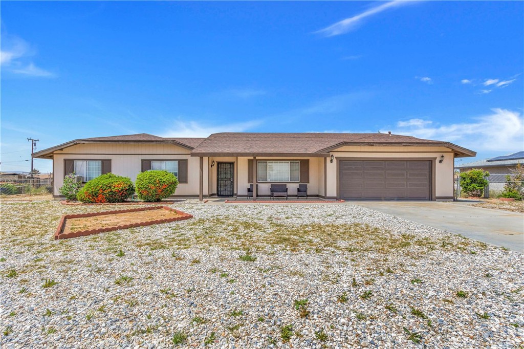 11180 Mohawk Road Apple Valley, CA 92308 - Photo 1 of 1 a front view of a house with garden