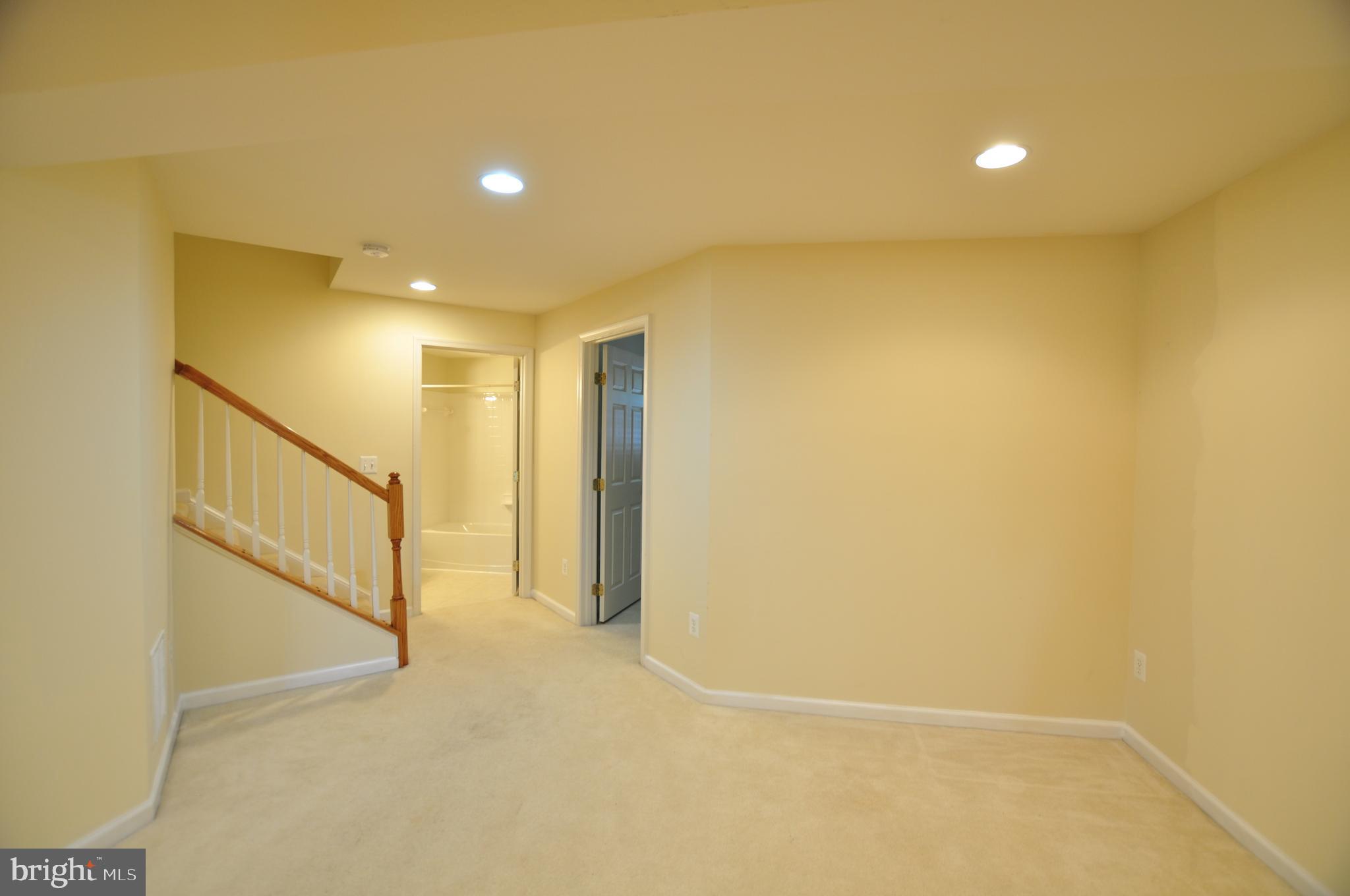 146 Riparian Lane Ranson, WV 25438 - Photo 31 of 42 Rec room view toward bathroom and third bedroom!