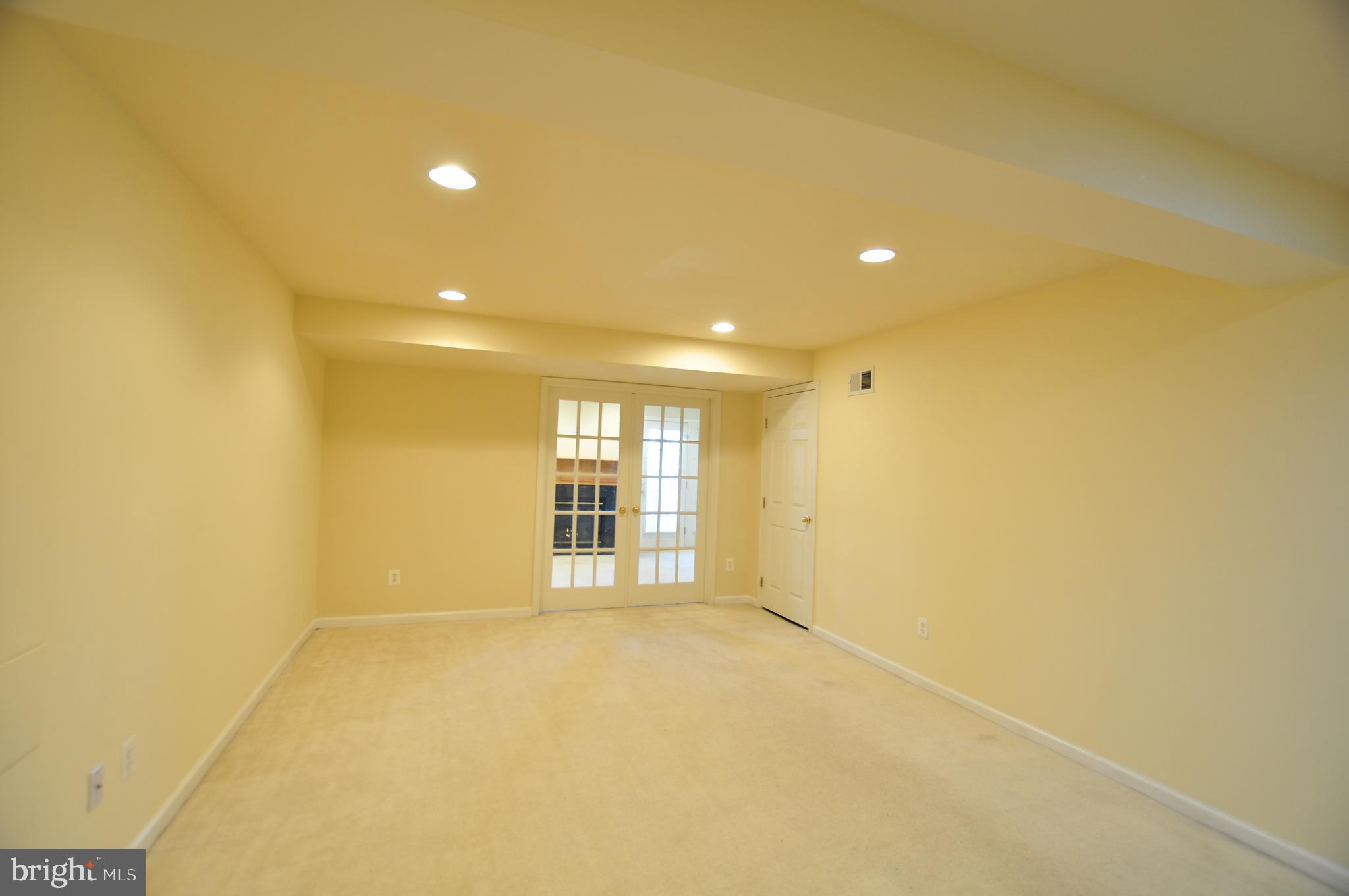 146 Riparian Lane Ranson, WV 25438 - Photo 32 of 42 Huge rec room view toward den/4th bedroom!