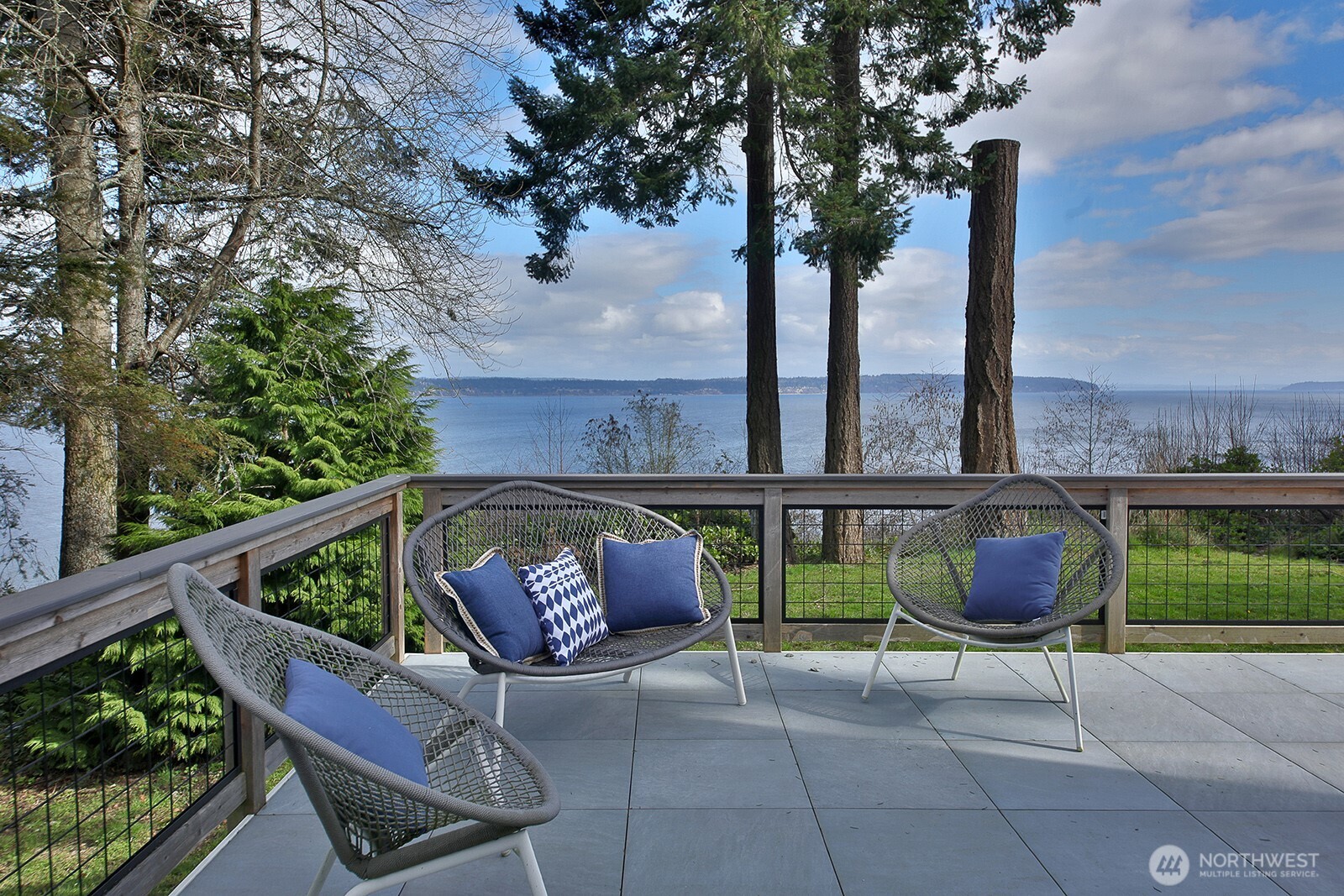 a balcony with outdoor seating and plants