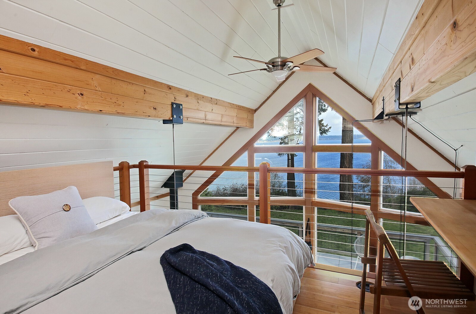 2282 East Whidbey Shores Road Langley, WA 98260 - Photo 17 of 38 a bedroom with a bed and a chandelier