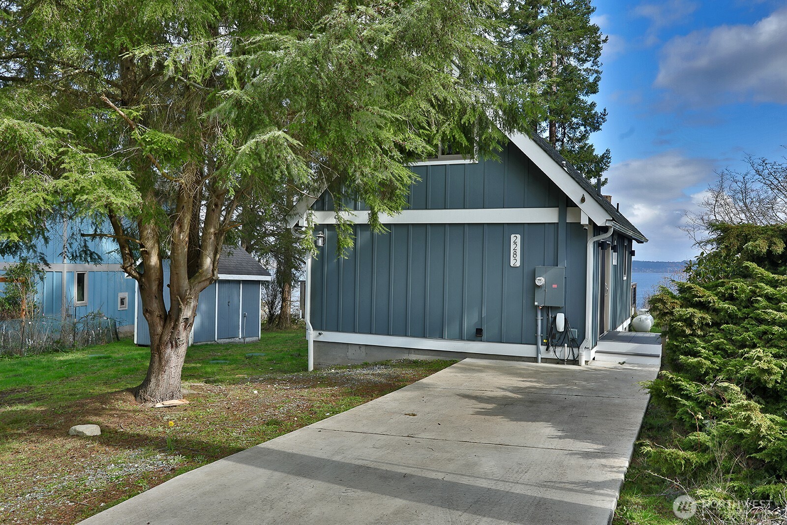 2282 East Whidbey Shores Road Langley, WA 98260 - Photo 22 of 38 a front view of a house with a yard and trees