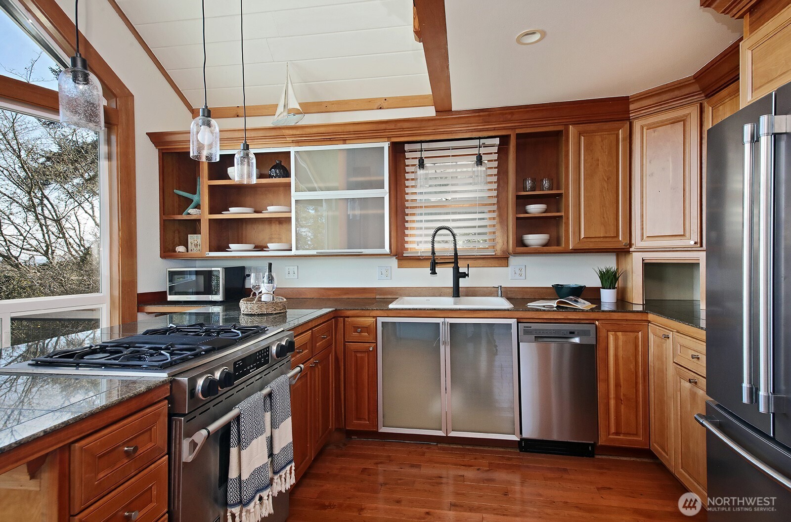 2282 East Whidbey Shores Road Langley, WA 98260 - Photo 9 of 38 a kitchen with stainless steel appliances granite countertop a stove sink and cabinets