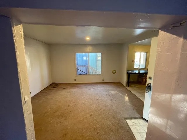 a view of an empty room with a fireplace