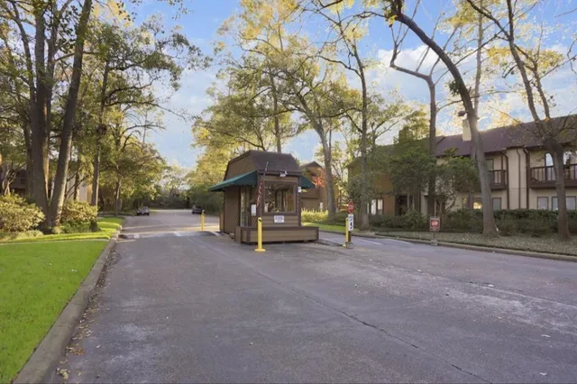 a view of a house with a large tree and a yard