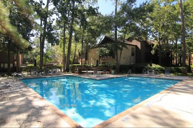 a view of a swimming pool with sitting area